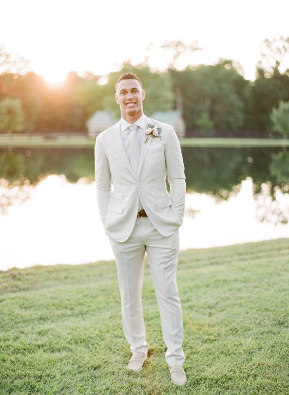 a white suit, shirt and tie plus creamy loafers are a lovely solution for a modern neutral wedding