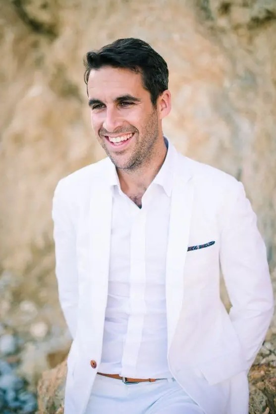 an all-white look without a tie plus an amber belt for modern beach groom style