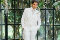 an elegant groom’s outfit with a white three-piece suit, a white shirt, a neutral tie and brown shoes will match many wedding themes and styles