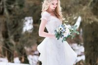 an embellished wedding dress with short sleeves and a ruffled overskirt on the back for an ice queen