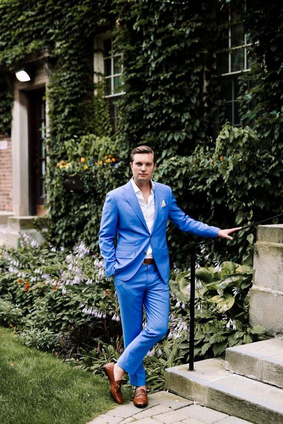 An eye catchy groom's look with a bold blue suit, a white shirt, brown loafers is a super cool and stylish idea