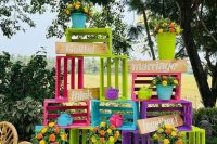 bright crate wedding decor with neon green, pink and blue crates and purple ones, bright blooms in pots