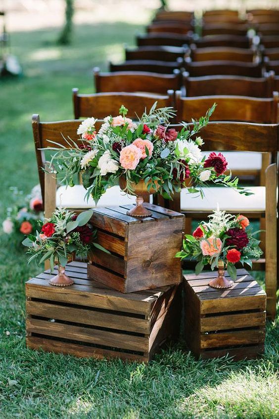 elegant wedding decor of crates, bold blooms and greenery in gold vases is amazing for summer or fall
