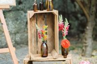 lovely and bold wedding decor with crates, bold blooms and greenery is a cool idea for any rustic wedding