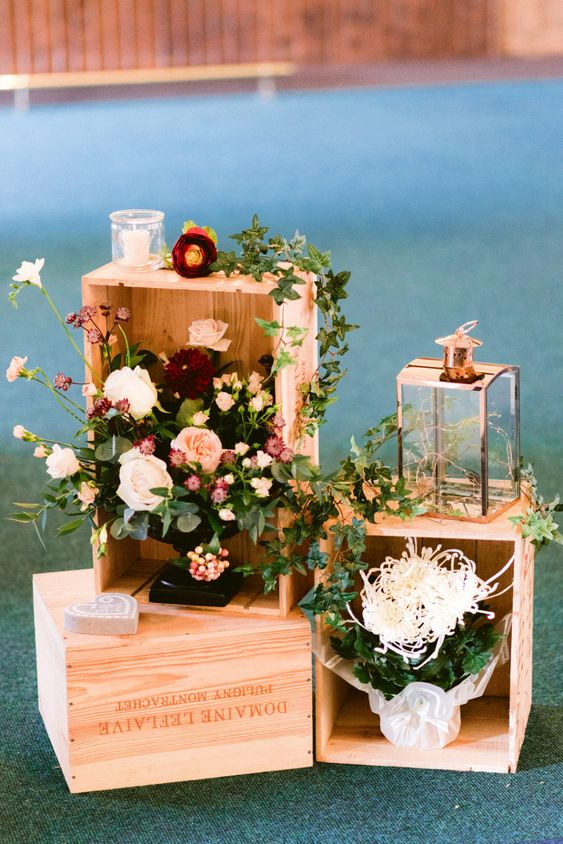 lovely rustic wedding decor with wooden crates, floral arrangements, candle lanterns can be easily repeated