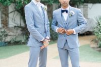 matching light blue three-piece suits, white shirts, bow ties, light brown shoes for matching grooms’ looks