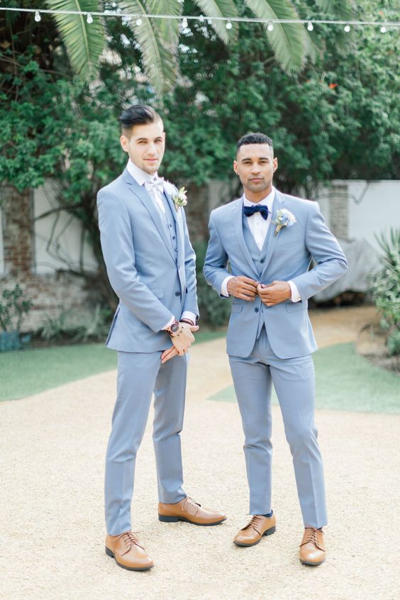 Matching light blue three piece suits, white shirts, bow ties, light brown shoes for matching grooms' looks