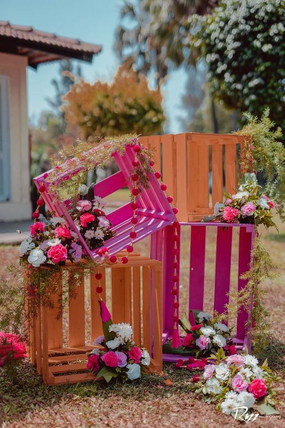 orange and fuchsia crates with bold pompoms and blooms are gorgeous for fun and cool backyard decor