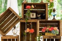 rustic vintage wedding decor with crates, vintage lamps, blooms and greenery and some other decor