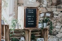 rustic wedding decor of crates, greenery, paper lamps, family pics and signs is amazing for rustic wedding