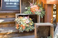 summer rustic wedding decor with crates, bold blooms and greenery and a chalkboard sign is amazing