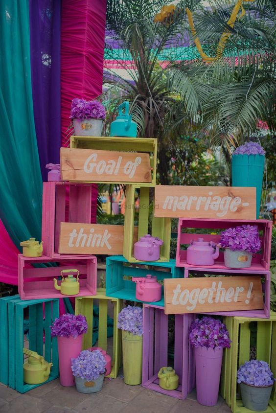 super bold crate wedding decor in pink, purple, turquoise, neon green, signs and bold blooms in pots