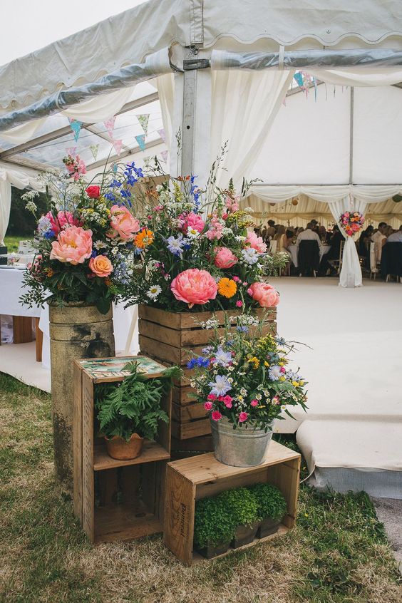 super bright and cool wedding decor with crates and boxes, potted plants and blooms is a lovely idea for summer