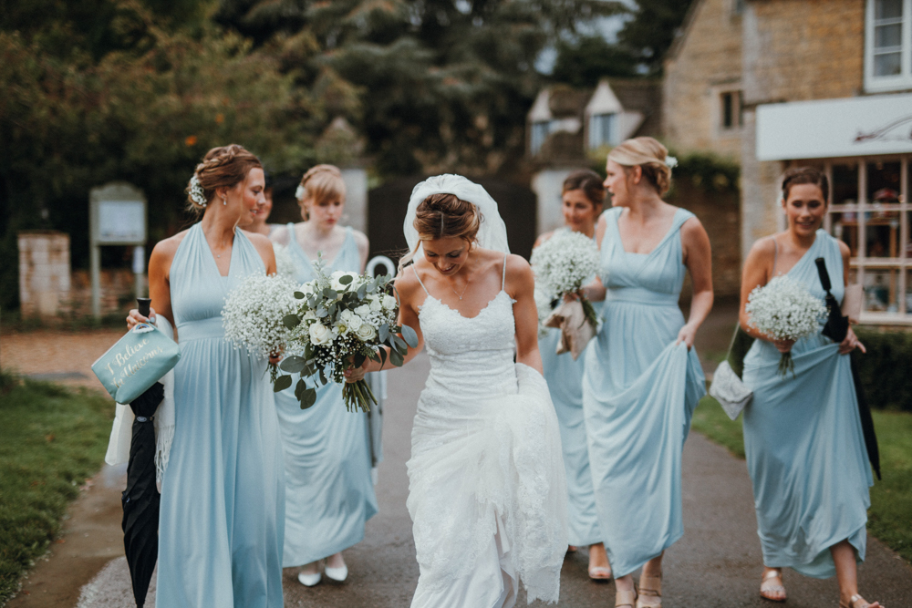 The bride was wearing a lace sheath dress with spaghetti straps, the bridesmaids were wearing light blue maxi dresses