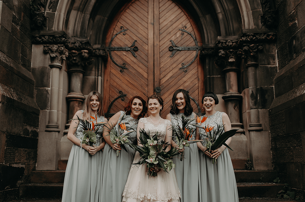 The bride was wearing a vintage-inspired midi dress with a lace bodice and the bridesmaids were rocking mint green maxi gowns