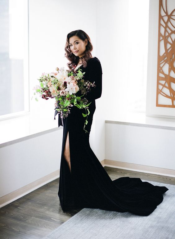 a black velvet long sleeve wedding dress with a V-neckline and a front slit for a wow look