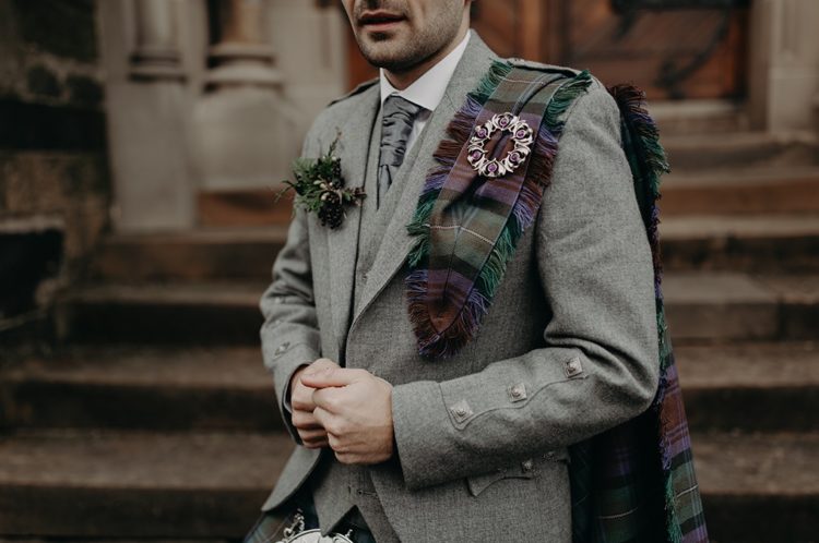 The groom was rocking his own kilt, a grey jacket, a grey vest and tie
