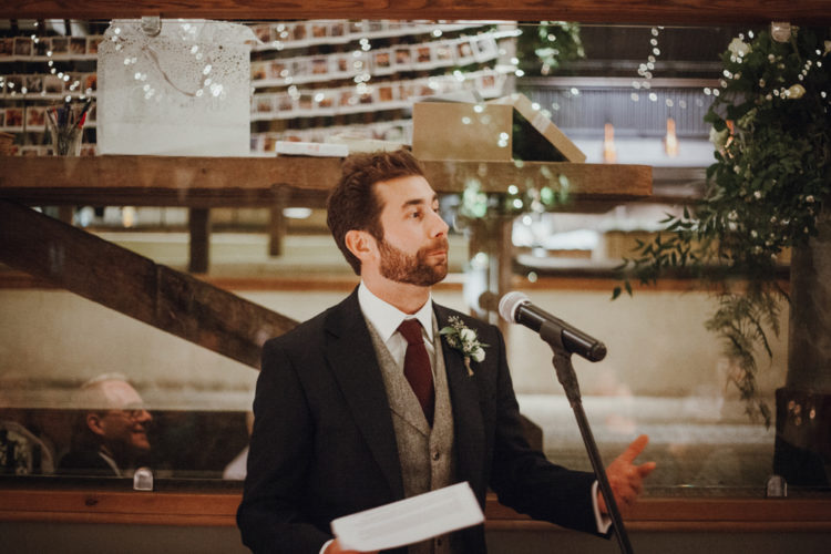The groom was wearing a grey tweed suit with a neutral waistcoat and a knitted burgundy tie