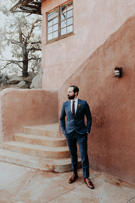 The groom was rocking a navy suit, a burgundy tie and burgundy shoes