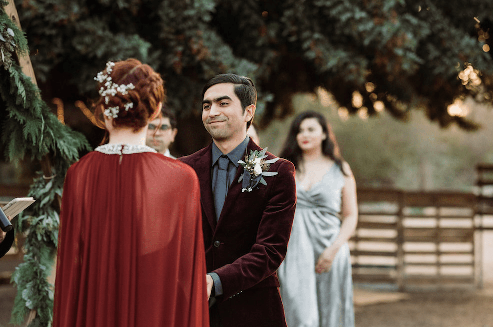 The groom was wearing a grey shirt, tie and a burgundy velvet jacket for a catchy look