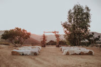 The wedding ceremony space was a boho rustic one with hay stacks and a cool  arch