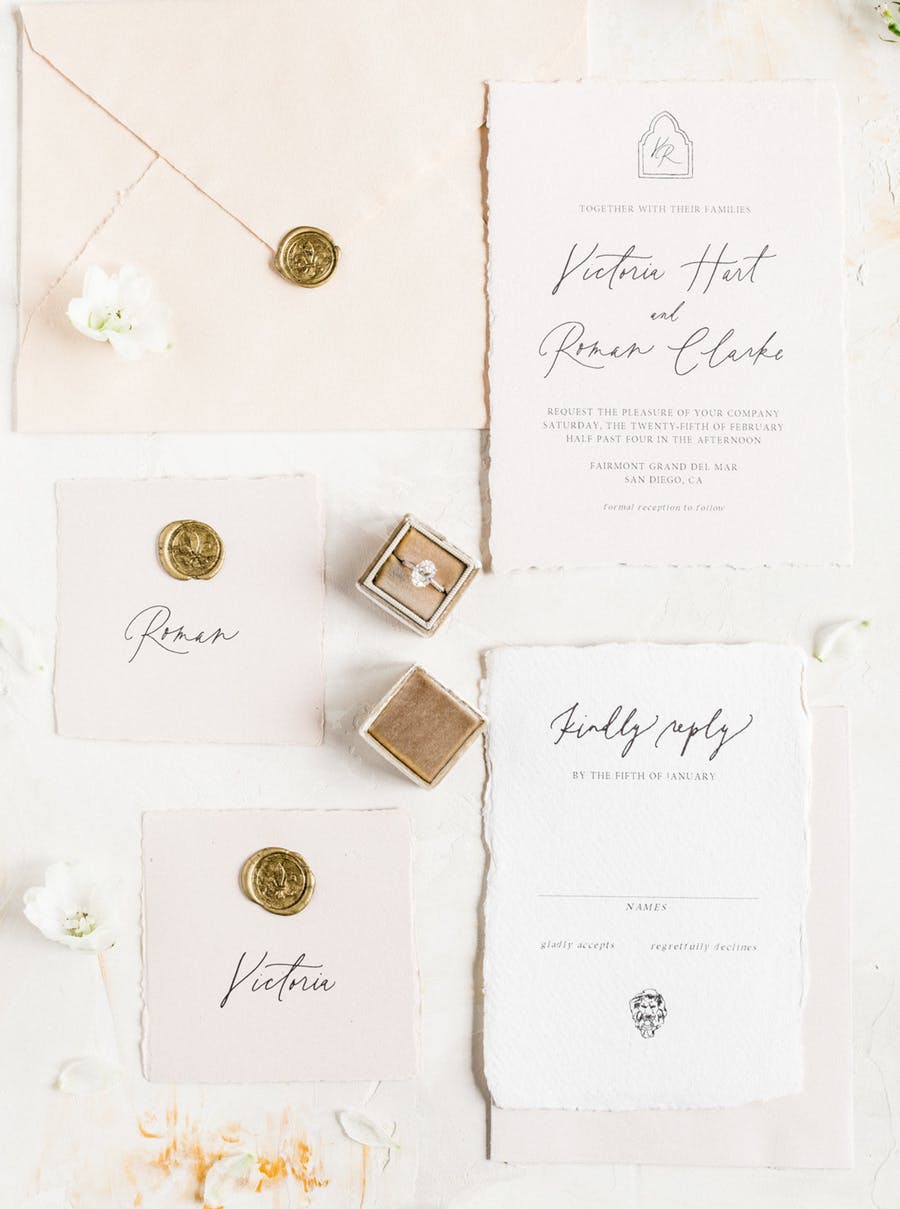 The wedding invitation suite was done in blush, with black calligraphy and gold stamps