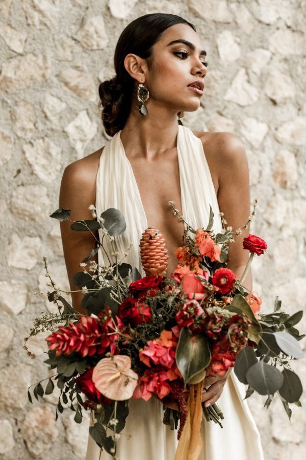 a tropical bride rocking statement copper and black geode earrings for a chic touch