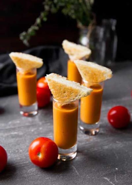 tomato bisque shooters with little cheese sandwiches for a simple appetizer