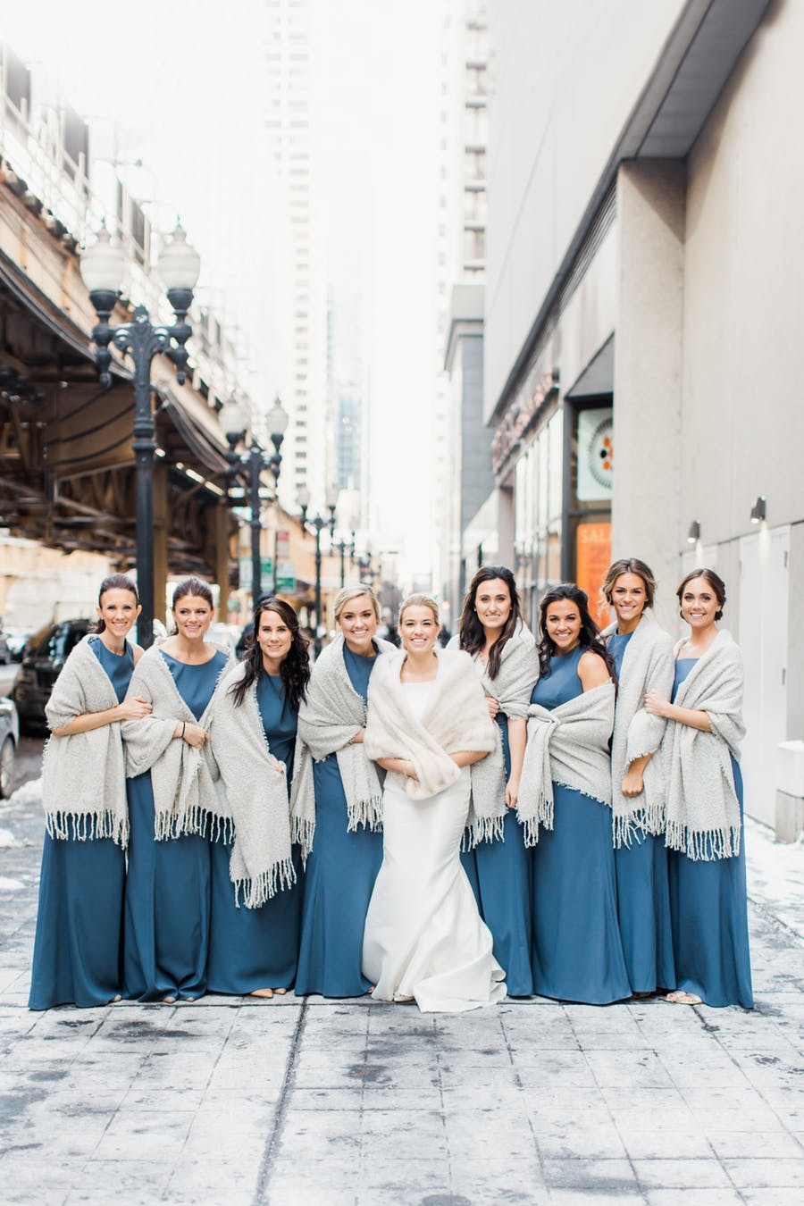 The bridesmaids were rocking muted blue dresses and covered up with pashminas