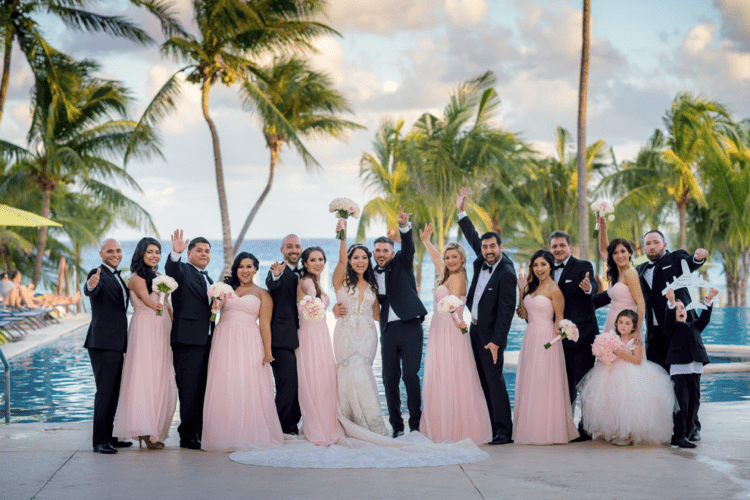 The groomsmen were rocking black tuxedos and the bridesmaids were wearing pink strapless maxi gowns