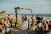 05 The wedding ceremony took place on the beach, the arch was amde of driftwood and decorated with bright flowers