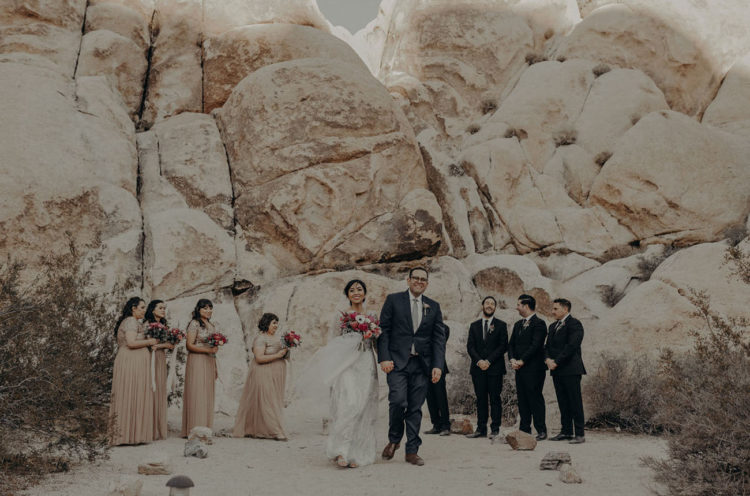 The bridesmaids were wearing flowy neutrals and the groomsmen were wearing black suits and ties