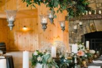 06 a dried branches and greenery wedding decoration with candle lanterns for a secret garden wedding