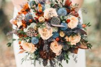 06 a moody round wedding bouquet done in orange, rust, grey, lilac and with blue touches plus some wildflowers