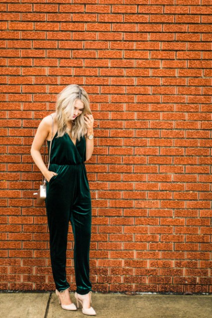 an emerald jumpsuit with a V-neckline, pockets, a metallic bag and nude shoes