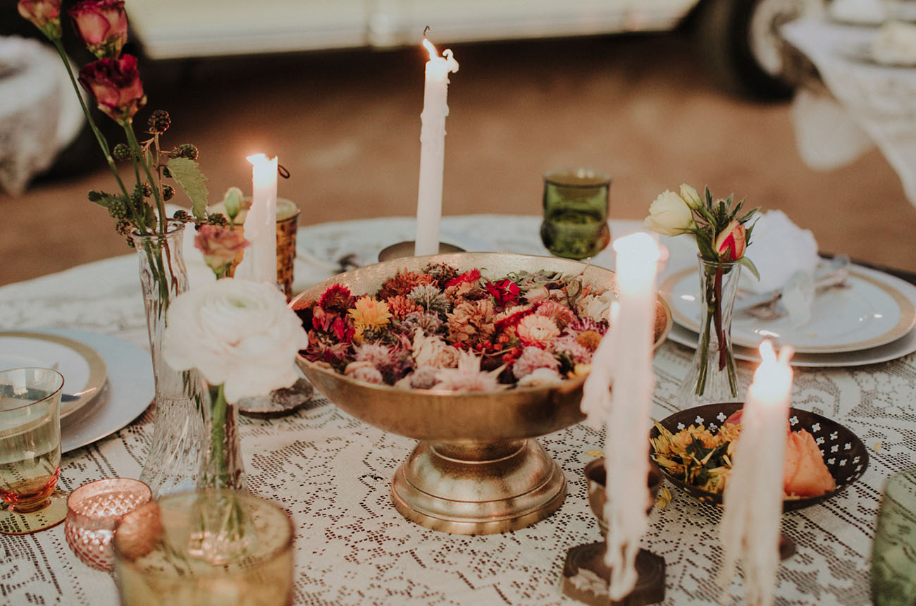 The wedding tablescape was done with lace, blooms and candles for an eclectic feel