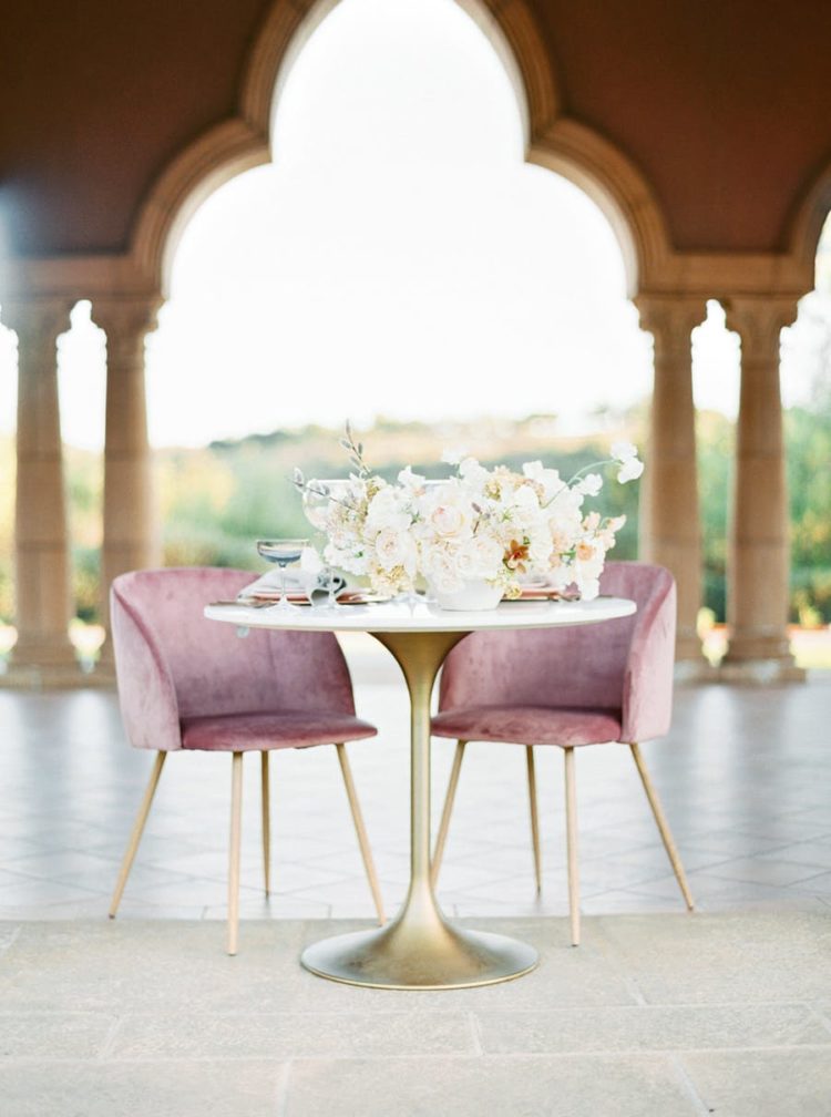 There was a sweetheart table done with a gold leg and dusty pink chairs with gold legs