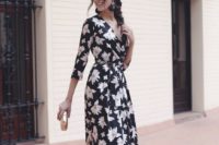 07 a black floral maxi dress with long sleeves and a V-neckline, black tassel earrrings, metallic shoes and a clutch