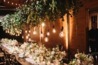 08 a lush greenery and floral wedding decoration with bulbs for refreshing the indoor space