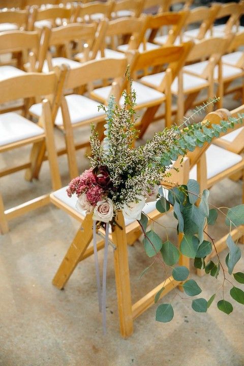 a lush floral arrangement with herbs and eucalyptus, burgundy and blush blooms