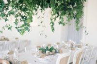 10 a super lush cascading wedding decoration overhead enlivens the neutral wedding reception