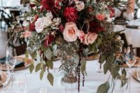10 a textural and lush wedding centerpiece of burgundy, blush and white blooms plus cascading greenery