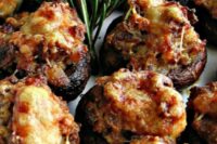 10 sausage and Asigo cheese stuffed mushrooms with fresh greenery is a warming up appetizer