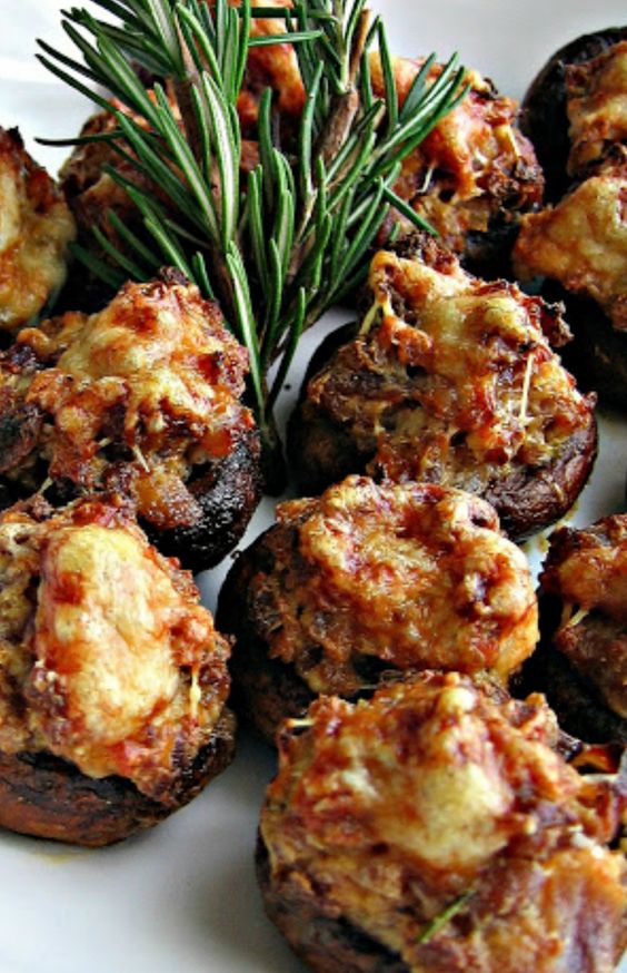 sausage and Asigo cheese stuffed mushrooms with fresh greenery is a warming up appetizer