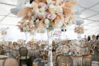 11 The reception tables were decorated with lush centerpieces with pampas grass, pink and white roses and gold touches