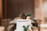 11 The wedding cake was a demi naked one topped with a pinecone, cinnamons and fir branches