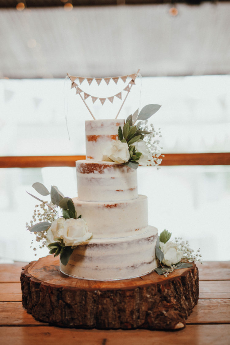 The wedding cake was a naked one, topped with fresh blooms and a bunting topper