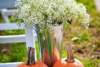 11 a bucket with baby’s breath and a couple of pumpkins for lining up a rustic fall aisle