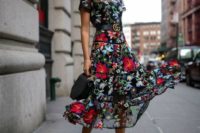 11 a moody floral midi dress with a sheer bodice and skirt, short sleeves and black shoes and a bag