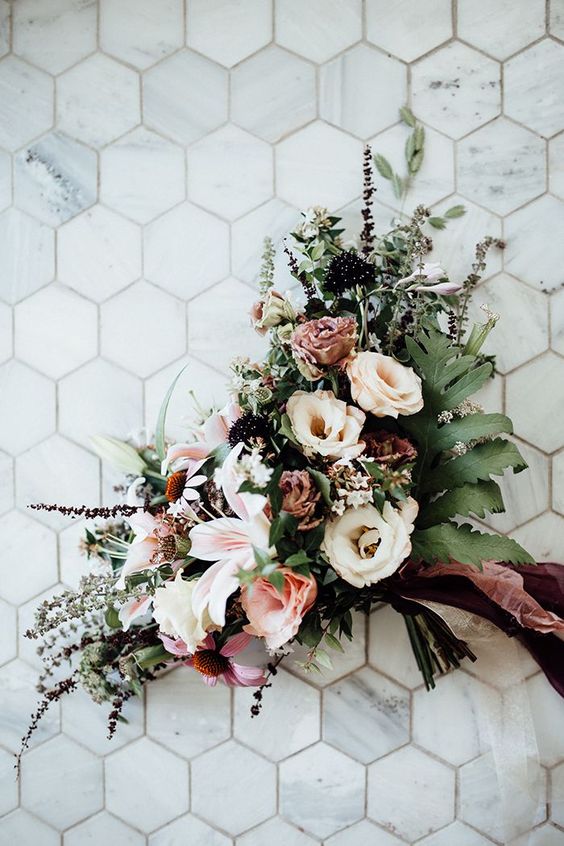 a chic lush woodland wedding bouquet with greenery, white and pink blooms and dark touches